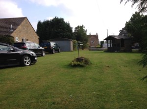 Looking down the length of the garden from front wall to garage